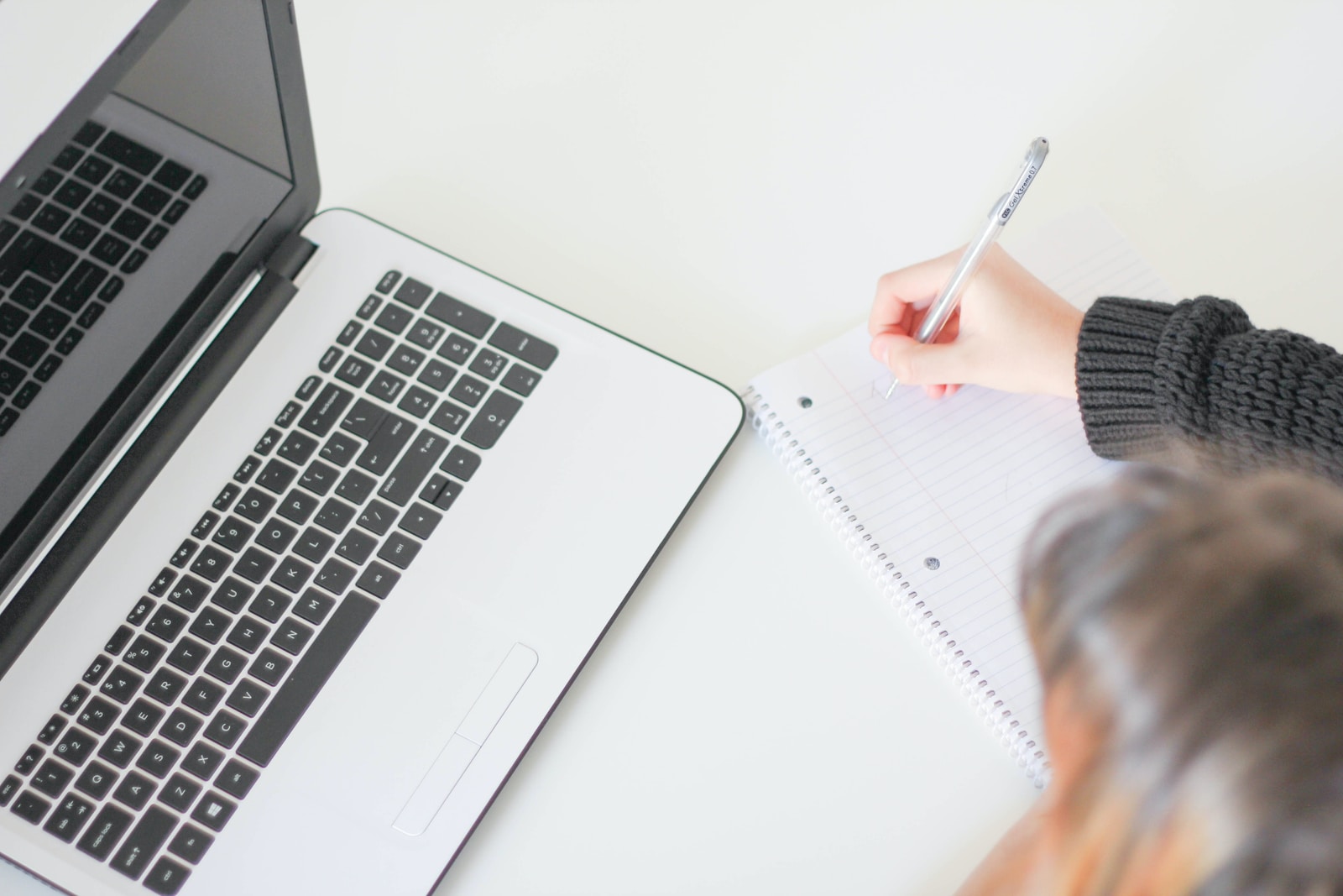 woman writing on notebook